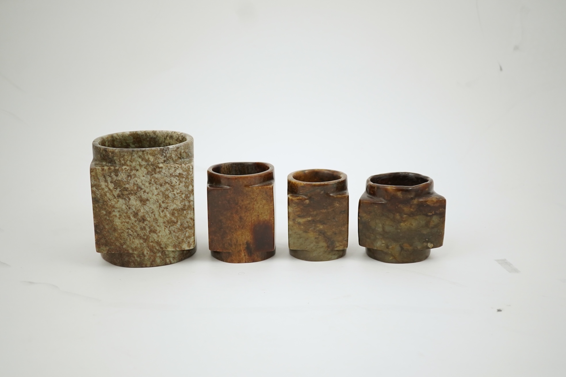 Four Chinese archaistic jade or hardstone cong